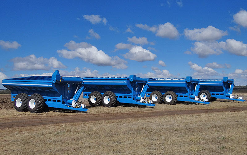 Blue tractors parked on the field